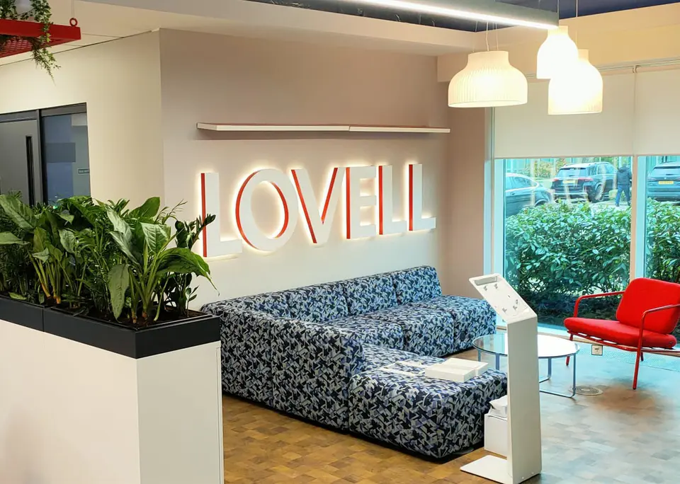 Large halo illuminated 3D lettering signage in office lobby